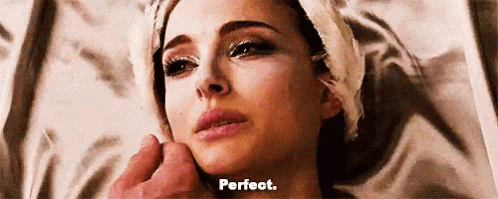 A Woman With A Towel Wrapped Around Her Head Is Laying Down And A Man Is Touching Her Face . GIF
