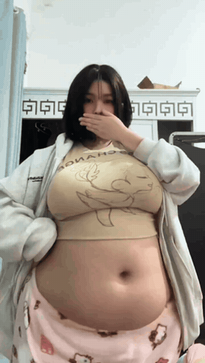 a woman with a very large belly is wearing a shirt that says donald duck
