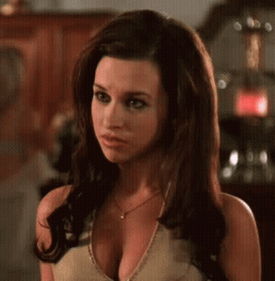 A Woman With A Very Large Breast Is Wearing A Necklace And A Tank Top . GIF