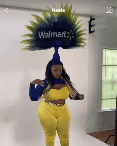 A Woman With A Walmart Logo On Her Head Stands In Front Of A White Wall GIF