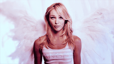 A Woman With Angel Wings Is Wearing A Tank Top With The Word Angel On It GIF