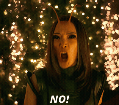 A Woman With Antennas On Her Head Says No In Front Of Christmas Lights GIF