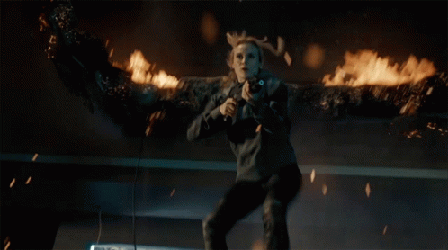A Woman With Antlers Is Holding A Gun In Her Hand GIF