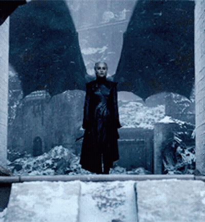 A Woman With Bat Wings Is Standing In Front Of A Window In The Snow GIF