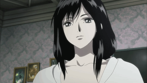 A Woman With Black Hair And A White Shirt Is Standing In Front Of A Pink Wall GIF