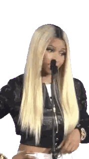 A Woman With Blonde Hair And A Black Jacket Is Standing In Front Of A Microphone . Sticker