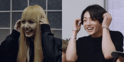 A Woman With Blonde Hair And A Man With Black Hair Are Smiling GIF