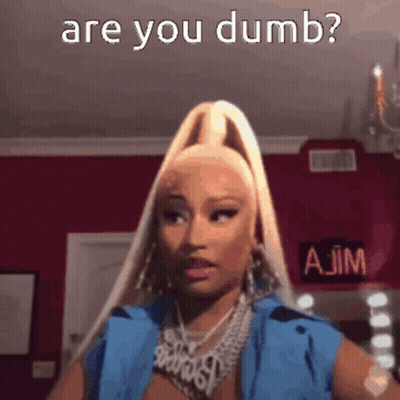 A Woman With Blonde Hair And A Ponytail Is Making A Funny Face And Asking If She Is Dumb . GIF