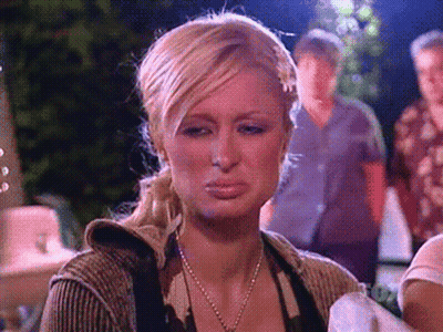 A Woman With Blonde Hair And A Ponytail Is Making A Sad Face GIF