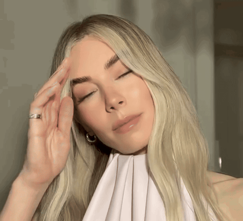 A Woman With Blonde Hair And A Ring On Her Finger GIF