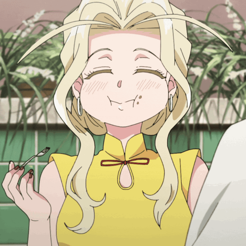 A Woman With Blonde Hair And A Yellow Shirt Is Smiling GIF