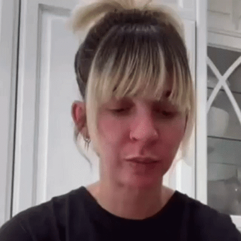 A Woman With Blonde Hair And Bangs Is Making A Funny Face With Her Mouth Open . GIF