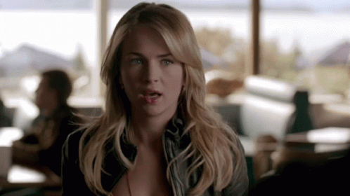 A Woman With Blonde Hair And Blue Eyes Is Looking At The Camera With A Surprised Look On Her Face GIF