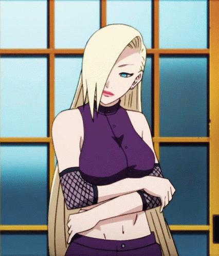 A Woman With Blonde Hair And Blue Eyes Is Standing In Front Of A Window With Her Arms Crossed GIF