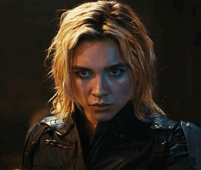 A Woman With Blonde Hair And Blue Eyes Is Wearing A Black Jacket GIF