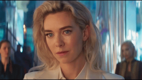 A Woman With Blonde Hair And Blue Eyes Is Wearing A White Shirt And Tie GIF