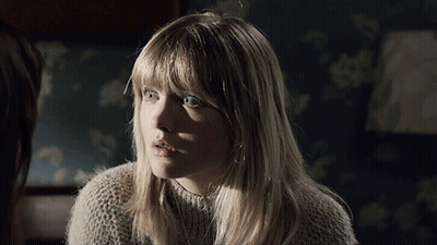 A Woman With Blonde Hair And Blue Eyes Looks Surprised GIF