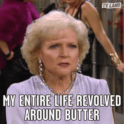A Woman With Blonde Hair And Earrings Is Sitting In Front Of A Group Of Women . GIF