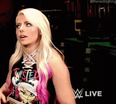 A Woman With Blonde Hair And Pink Highlights Is Wearing A T-Shirt That Says ' Wise ' On It . GIF