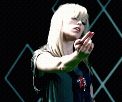 A Woman With Blonde Hair And Red Nails Is Making A Middle Finger Gesture GIF