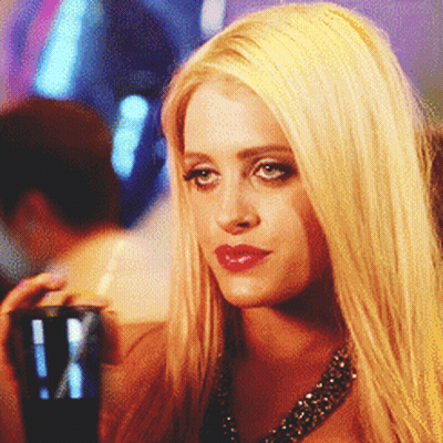 A Woman With Blonde Hair Is Holding A Cup With A Straw In Her Hand GIF