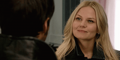 A Woman With Blonde Hair Is Looking At A Man GIF