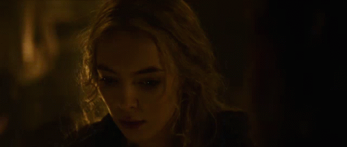 A Woman With Blonde Hair Is Looking At The Camera GIF