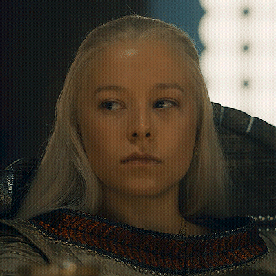 A Woman With Blonde Hair Is Looking At The Camera GIF