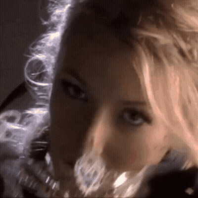 A Woman With Blonde Hair Is Looking At The Camera GIF