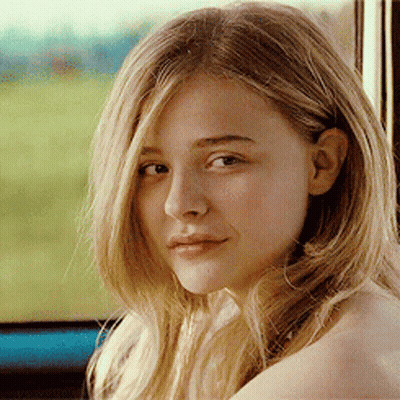 A Woman With Blonde Hair Is Looking At The Camera GIF