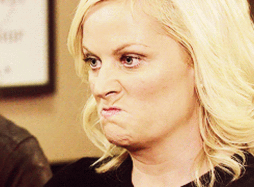 A Woman With Blonde Hair Is Making A Face GIF