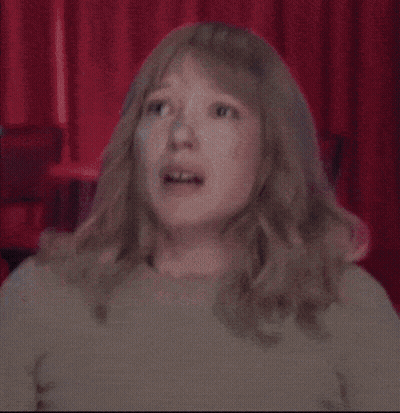 A Woman With Blonde Hair Is Making A Funny Face GIF