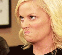 A Woman With Blonde Hair Is Making A Funny Face . GIF