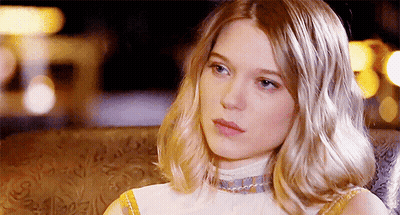 A Woman With Blonde Hair Is Sitting In A Chair GIF