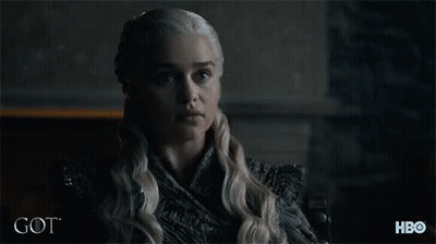 A Woman With Blonde Hair Is Sitting In Front Of A Sign That Says Hbo GIF