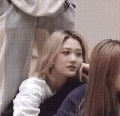A Woman With Blonde Hair Is Sitting Next To A Group Of Women . GIF