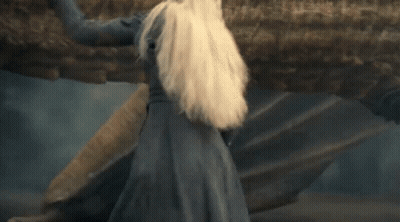 A Woman With Blonde Hair Is Smiling And Looking Up GIF