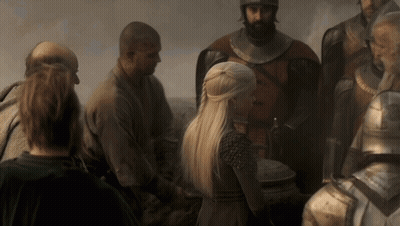 A Woman With Blonde Hair Is Standing In A Crowd Of People GIF