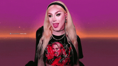 A Woman With Blonde Hair Is Wearing A Black Shirt With A Picture Of A Woman On It GIF