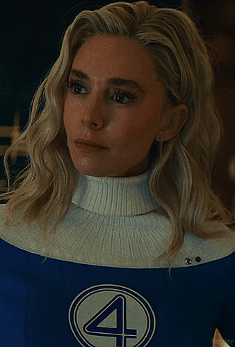 A Woman With Blonde Hair Is Wearing A Blue And White Costume With The Number 4 On It GIF