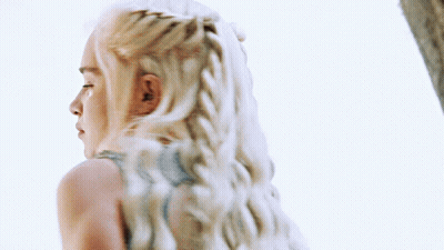 A Woman With Blonde Hair Is Wearing A Blue Top GIF