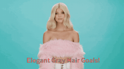 A Woman With Blonde Hair Is Wearing A Pink Fur Coat GIF