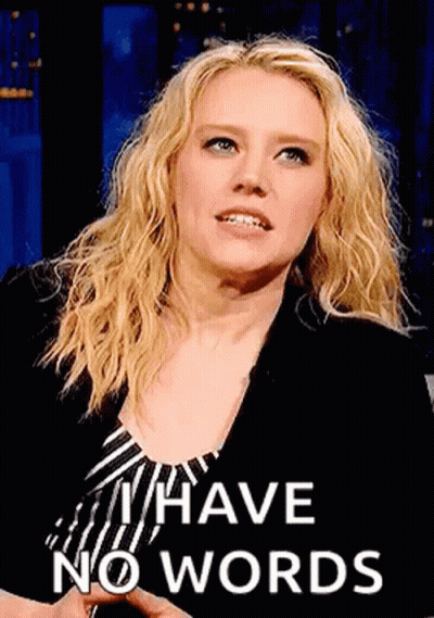 A Woman With Blonde Hair Is Wearing A Striped Shirt And A Black Jacket . GIF