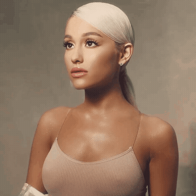 A Woman With Blonde Hair Is Wearing A Tank Top GIF