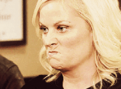 A Woman With Blonde Hair Making A Funny Face With Her Mouth Open GIF