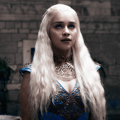 A Woman With Blonde Hair Wearing A Blue And Gold Dress GIF