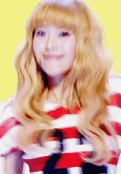 A Woman With Blonde Hair Wearing A Striped Shirt GIF