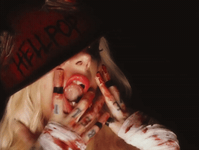 A Woman With Blood On Her Face And A Hat That Says Hell Pop GIF
