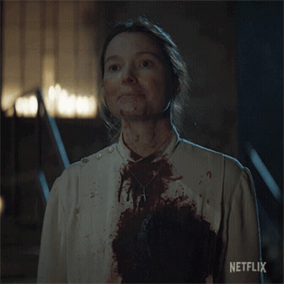 A Woman With Blood On Her Face And A Netflix Logo On The Bottom Right GIF
