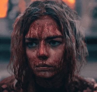 A Woman With Blood On Her Face Looking At The Camera GIF